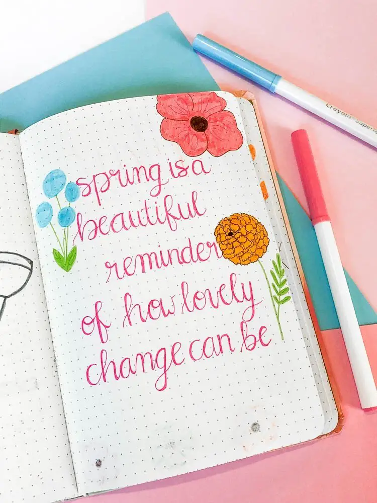 Bullet journal spring quote page with wildflowers