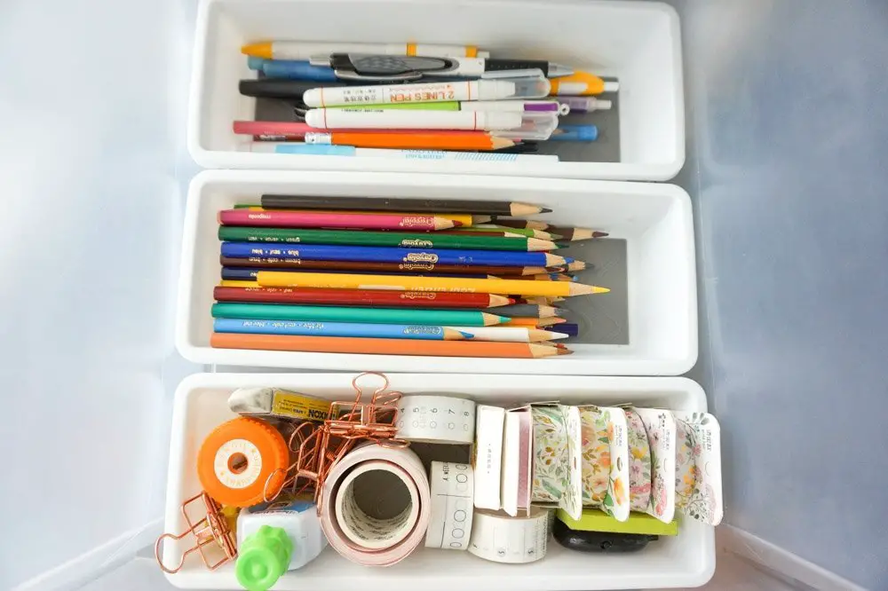 stationery and office supplies inside plastic organizers