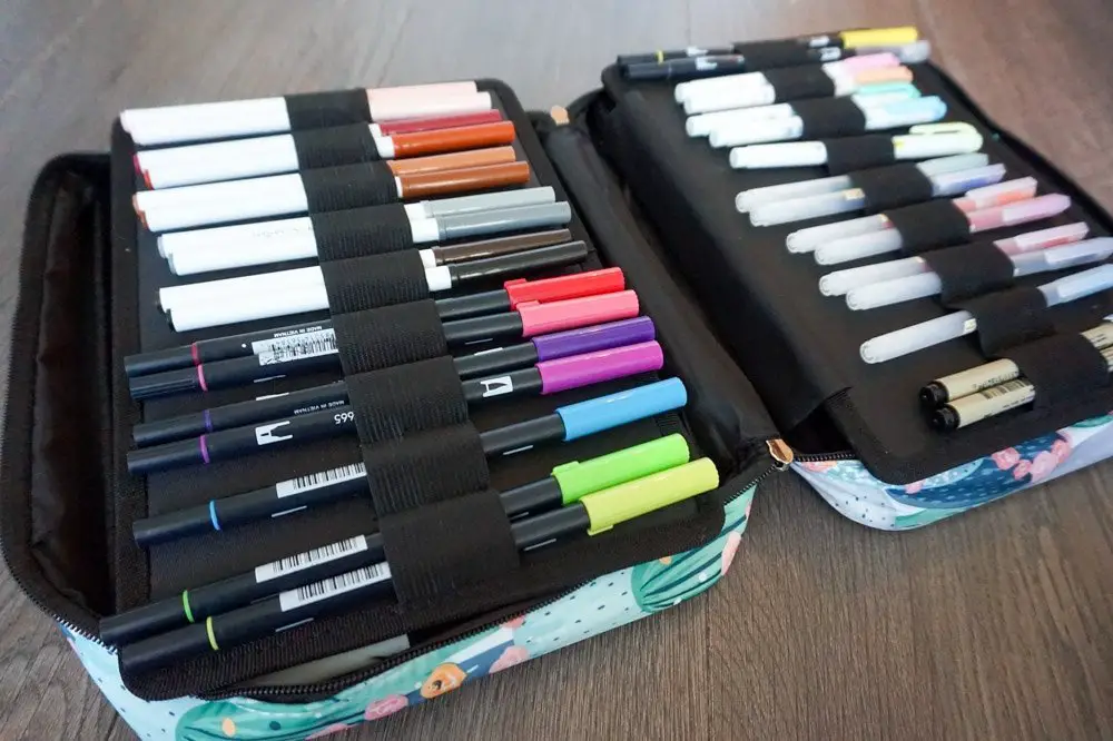 markers and brush pens inside pencil case