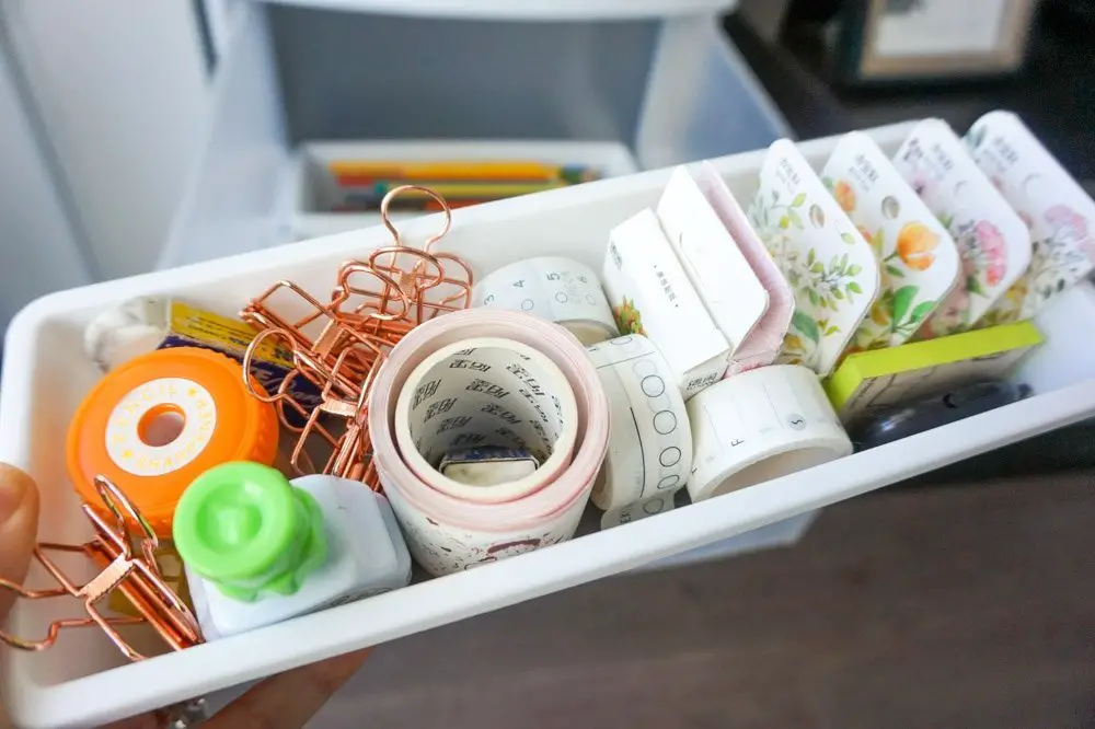 stationery and office supplies inside plastic organizers