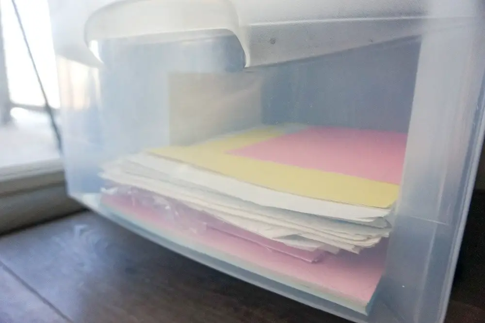 stack of paper inside plastic drawer