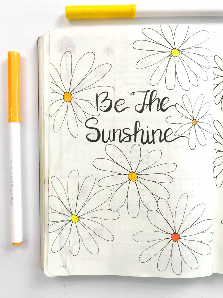 daisy theme bullet journal quote page: be the sunshine in black letters surrounded by daisies