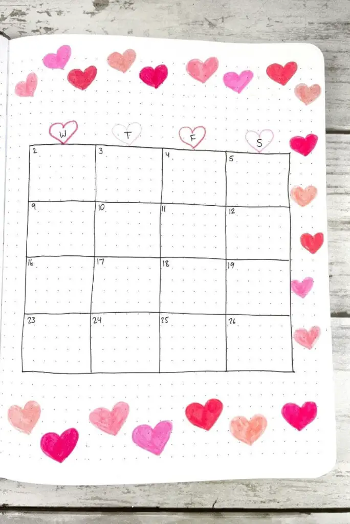 February bullet journal calendar filled with pink hearts