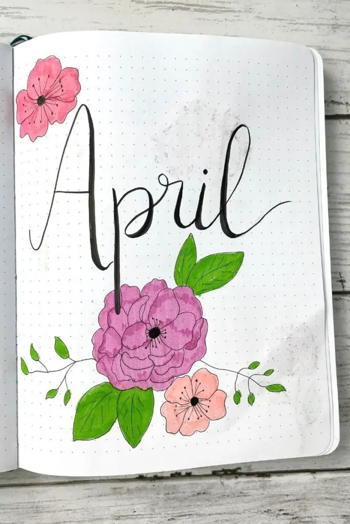 April bullet journal cover page filled with flowers