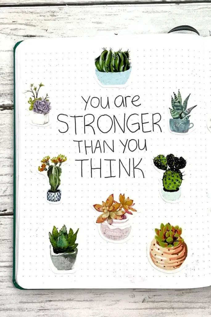 bullet journal quote page with text "you are stronger than you think," filled with succulent stickers