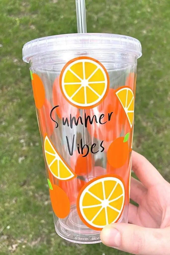 DIY summer vibes tumbler covered with orange slice vinyl decals